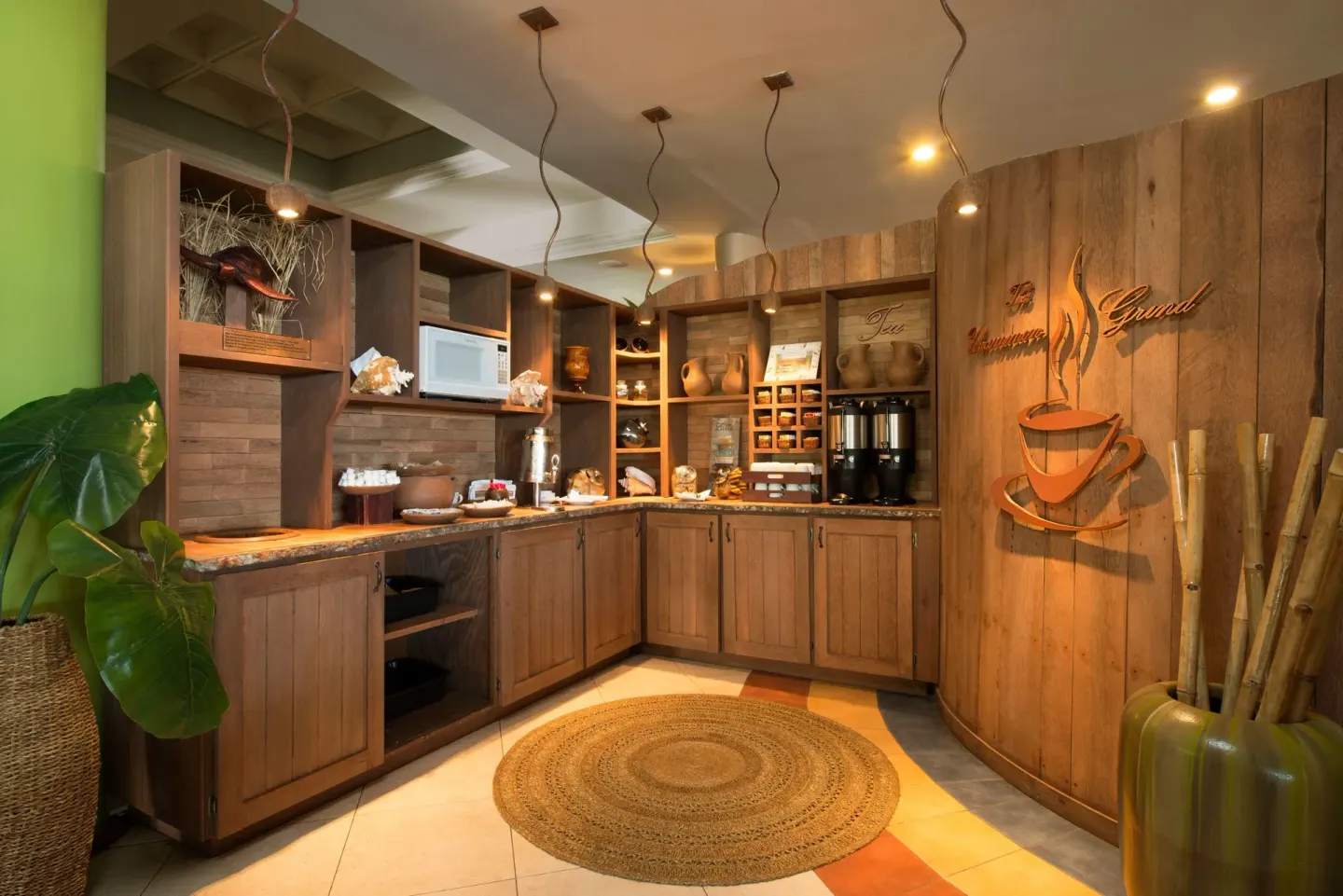 Self-serve coffee and tea station with wood cabinetry at Coconut Bay Beach Resort & Spa.