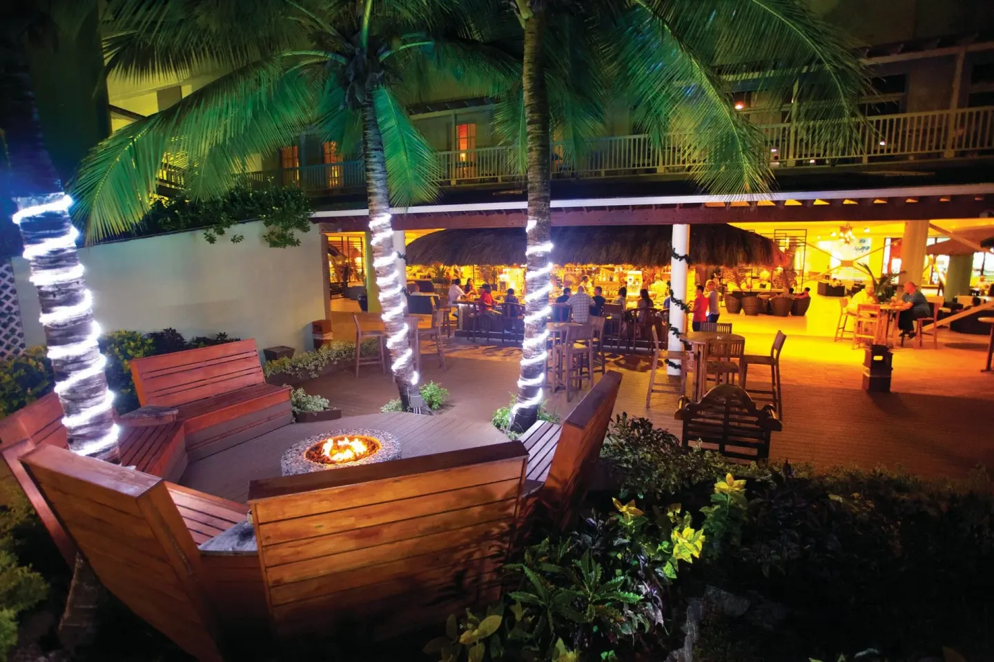 Nighttime outdoor seating with fire feature at Coconut Bay Beach Resort & Spa.