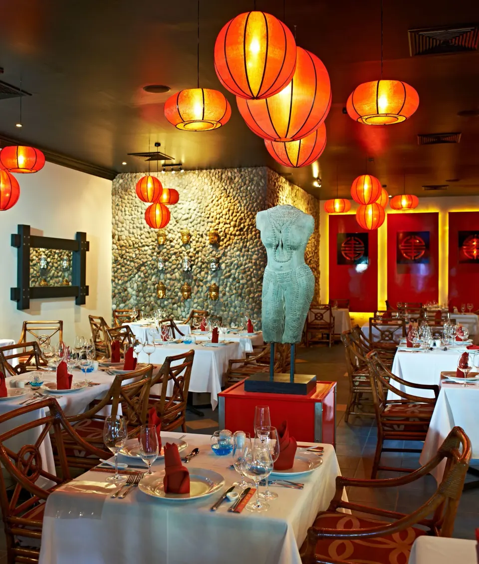 Asian-inspired dining room with red lanterns at Coconut Bay Beach Resort & Spa.