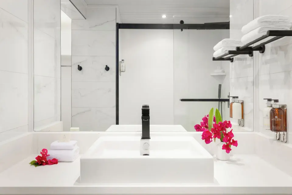 Harmony JR Suite Partial Ocean View bathroom vanity at Coconut Bay Beach Resort & Spa with sink and towels.