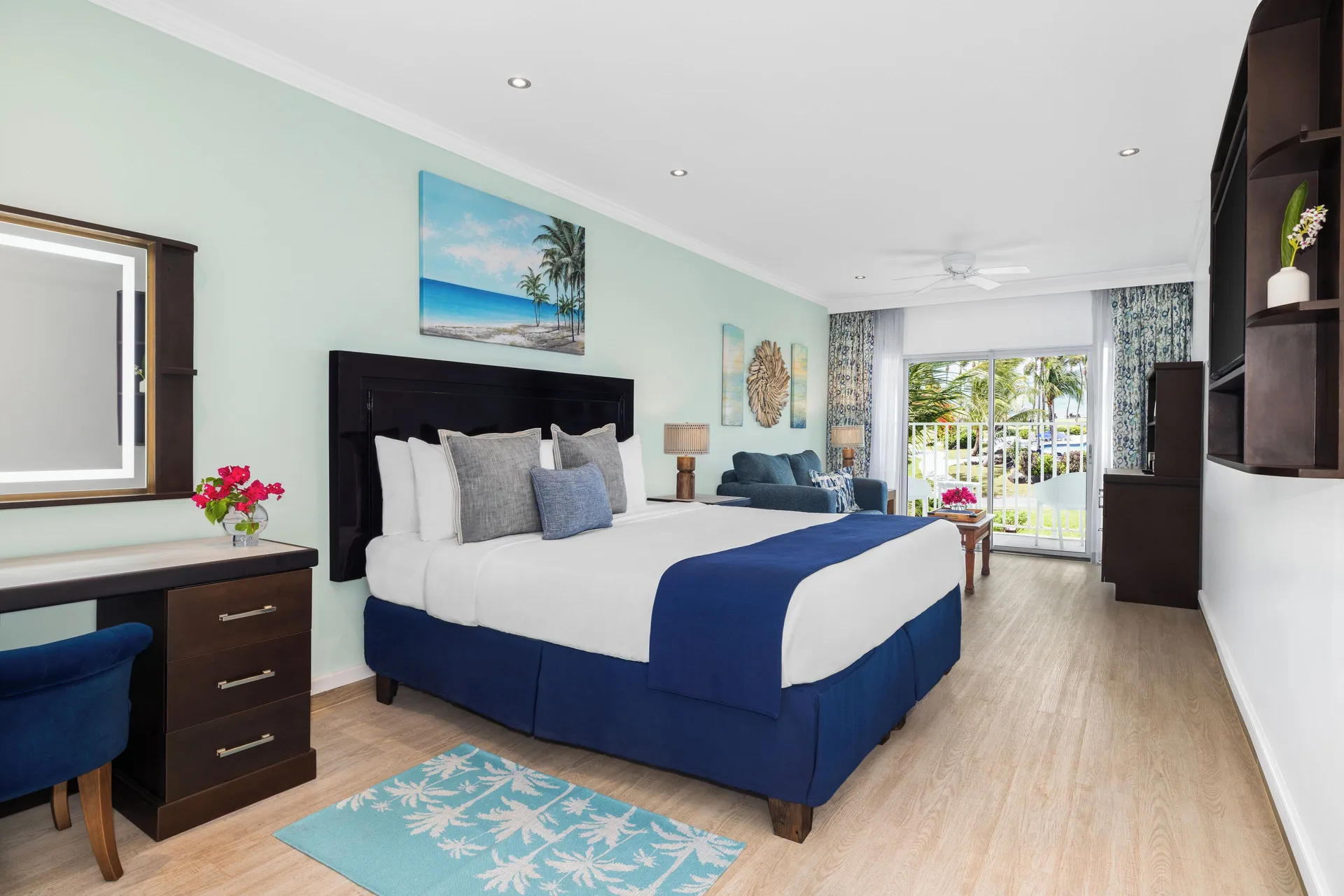 Harmony JR Suite Partial Ocean View king room at Coconut Bay Beach Resort & Spa with balcony at the far end.