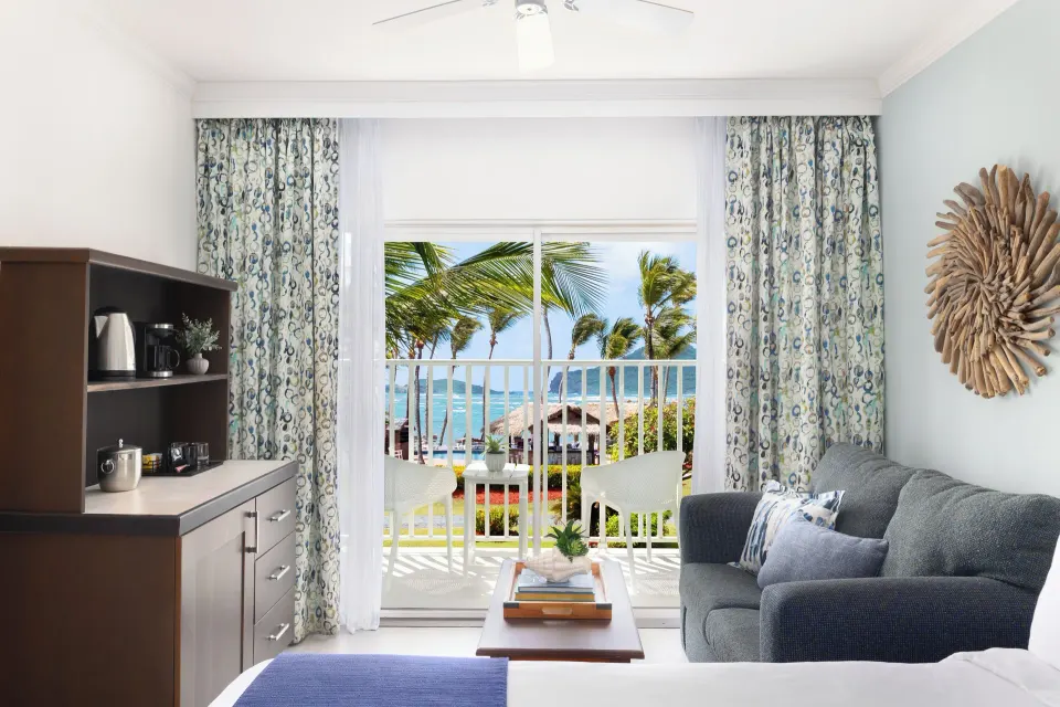 Harmony JR Suite Partial Ocean View sitting area at Coconut Bay Beach Resort & Spa with balcony and ocean.