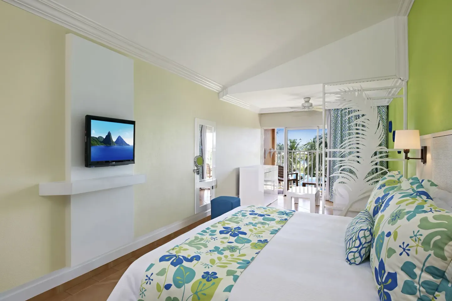Splash Concierge Premium Oceanview king bedroom at Coconut Bay Beach Resort & Spa with balcony beyond.