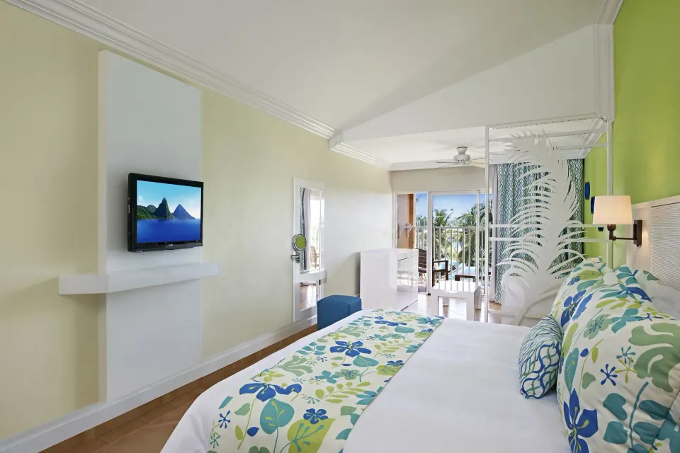 Splash Concierge Premium Oceanview king bedroom at Coconut Bay Beach Resort & Spa with balcony beyond.
