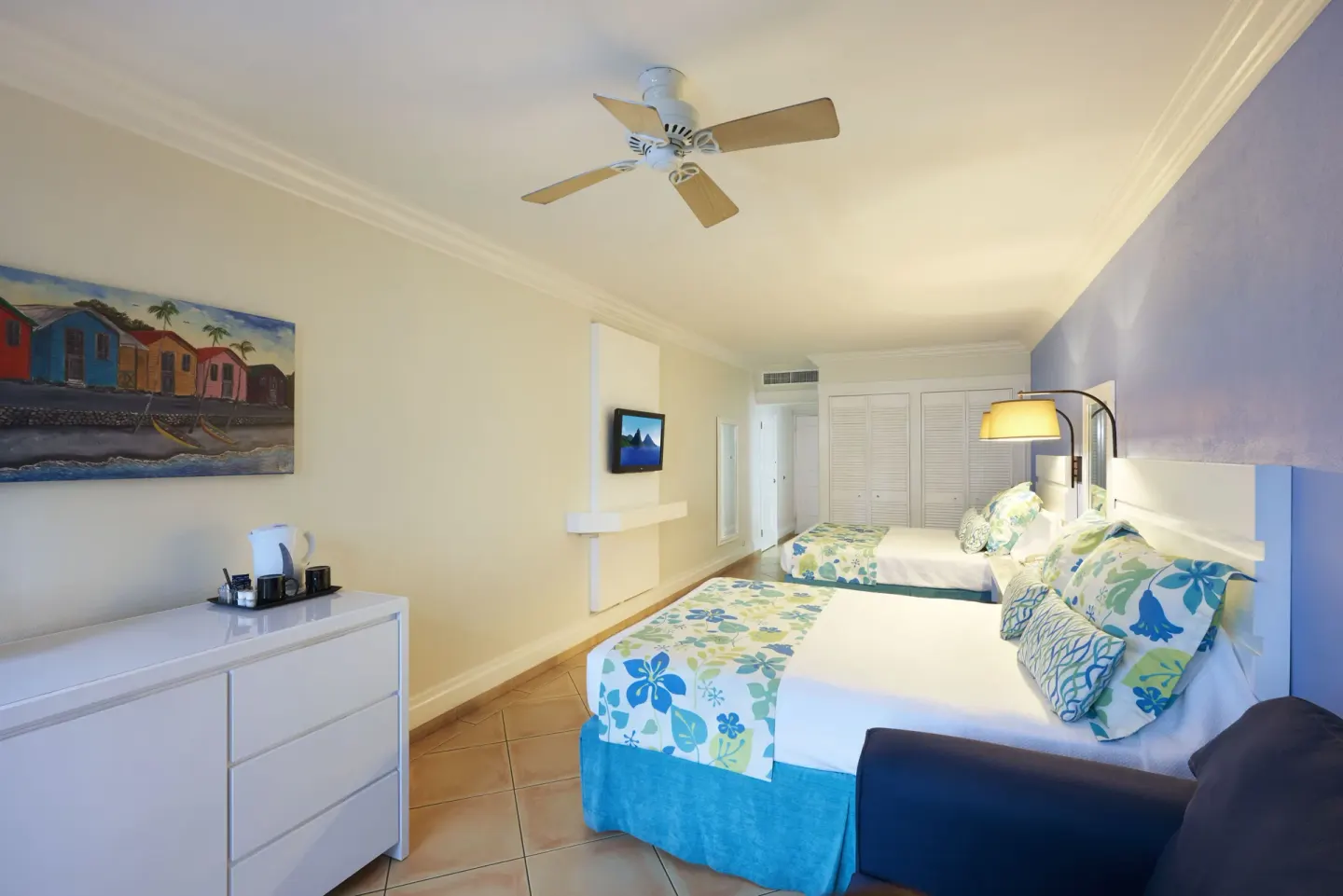 Two double beds and dresser in a Splash Deluxe Garden View room at Coconut Bay Beach Resort & Spa.