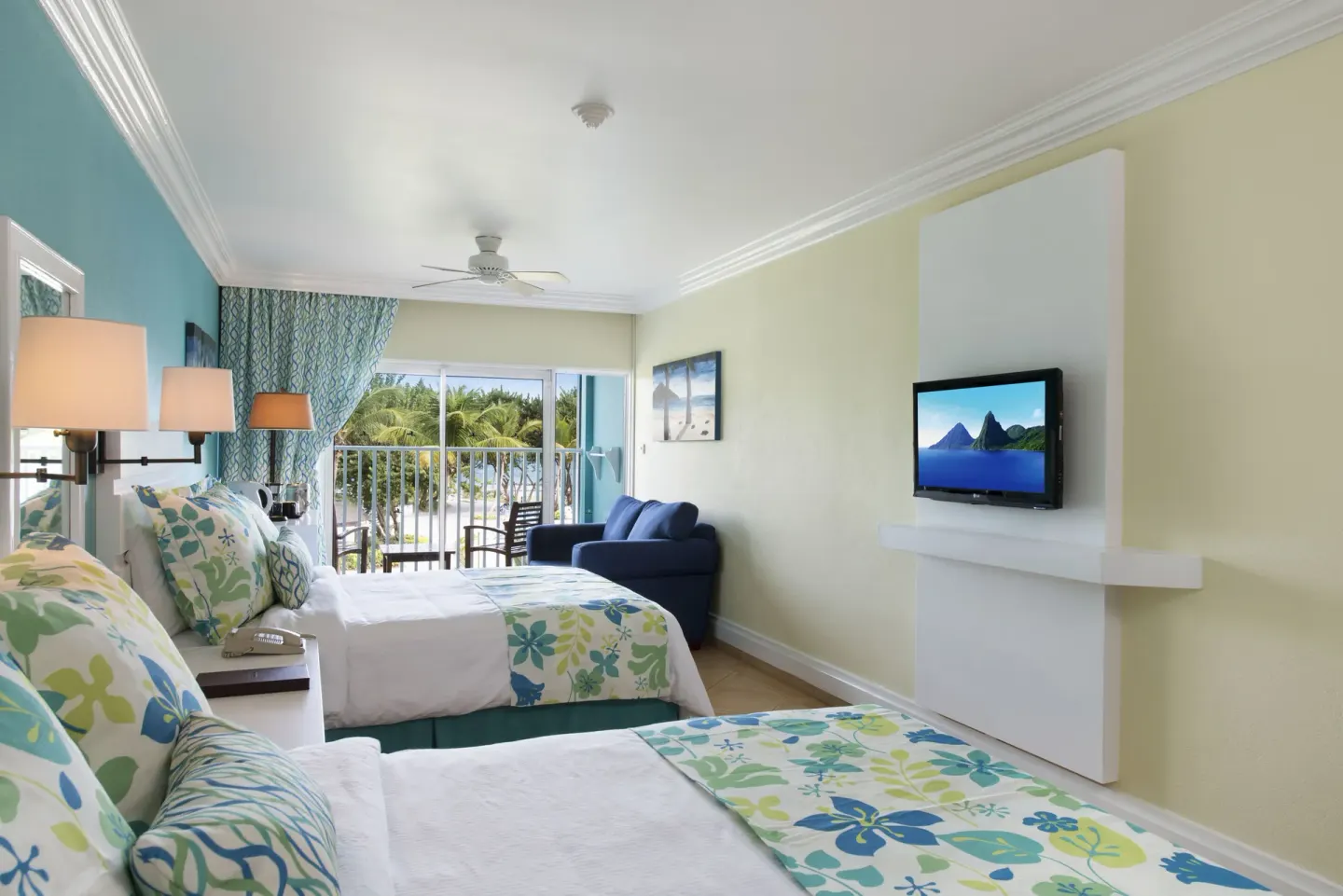 Two double beds in a Splash Premium Oceanview room at Coconut Bay Beach Resort & Spa with balcony seating.