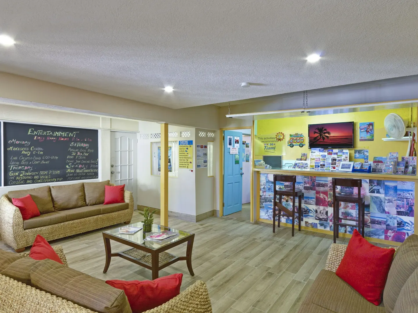 Guest information lounge with sofas and brochure counter at Coconut Court Beach Hotel.