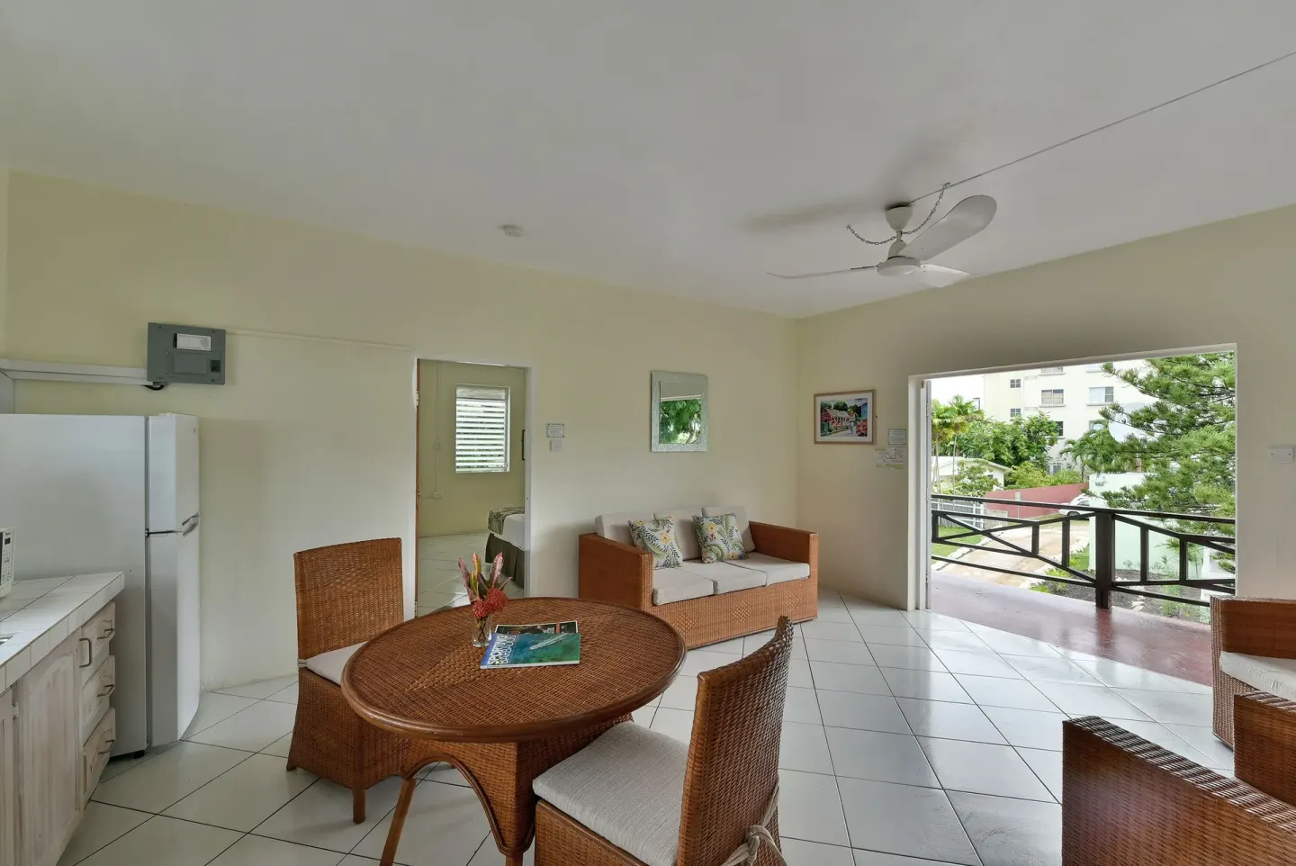 Guest room living and dining area with balcony opening at Coconut Court Beach Hotel.