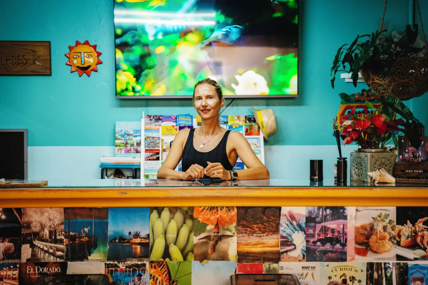 Guest services counter with brochures and attendant at Coconut Court Beach Hotel.