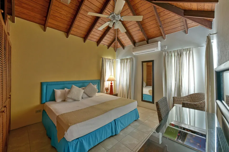 King bedroom with vaulted wood ceiling in the apartment at Coconut Court Beach Hotel.