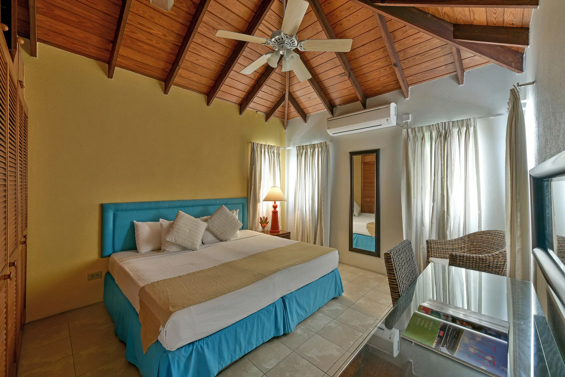 King bedroom with vaulted wood ceiling in the apartment at Coconut Court Beach Hotel.