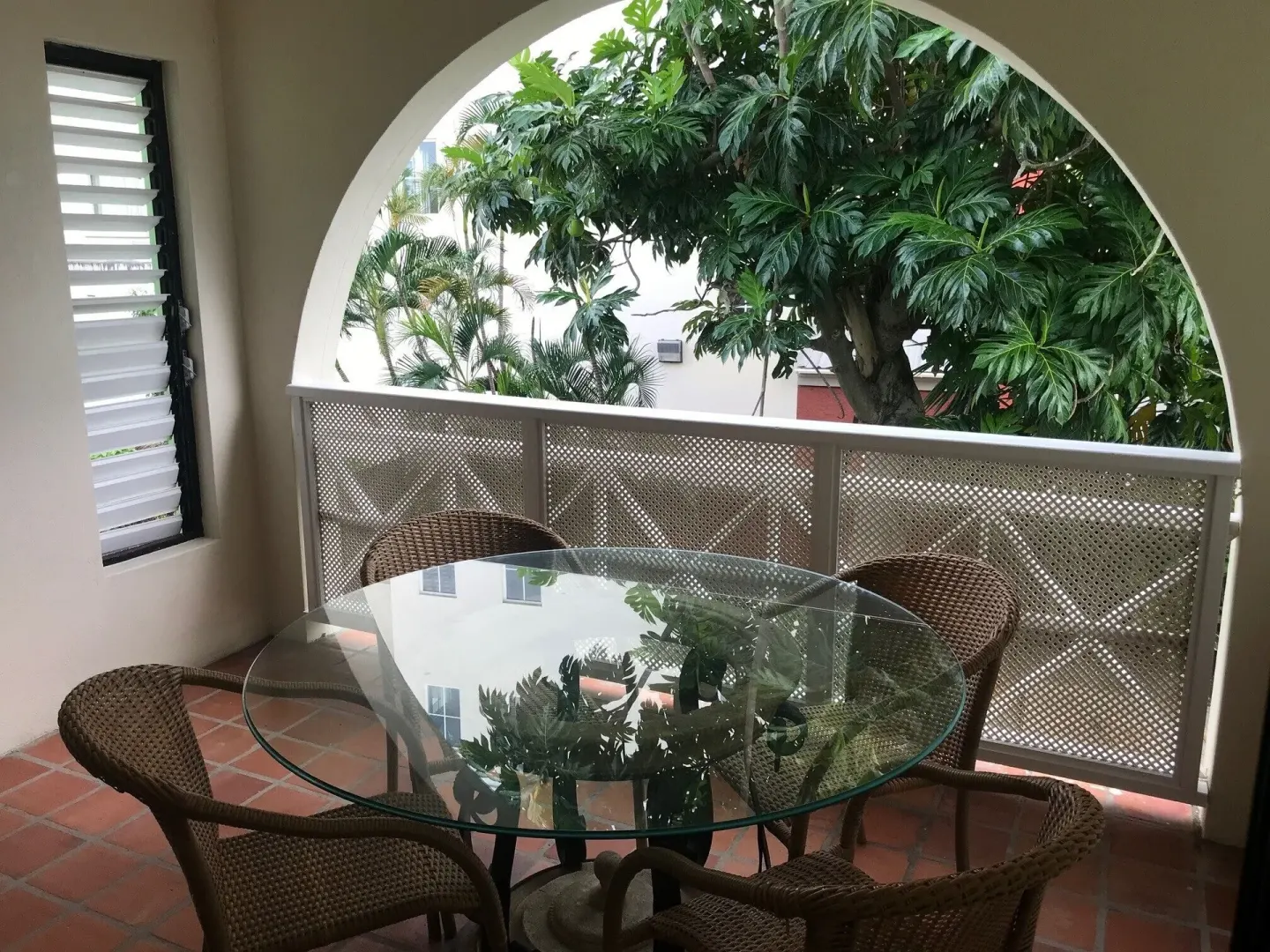 Balcony dining area in a two-bedroom annex apartment at Coconut Court Beach Hotel.