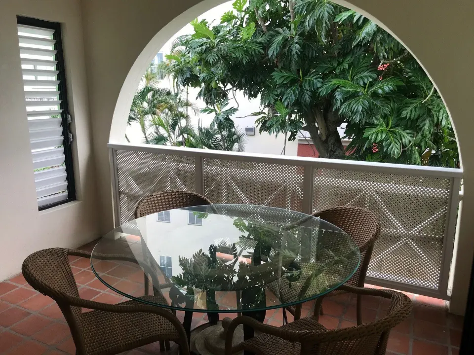 Balcony dining area in a two-bedroom annex apartment at Coconut Court Beach Hotel.