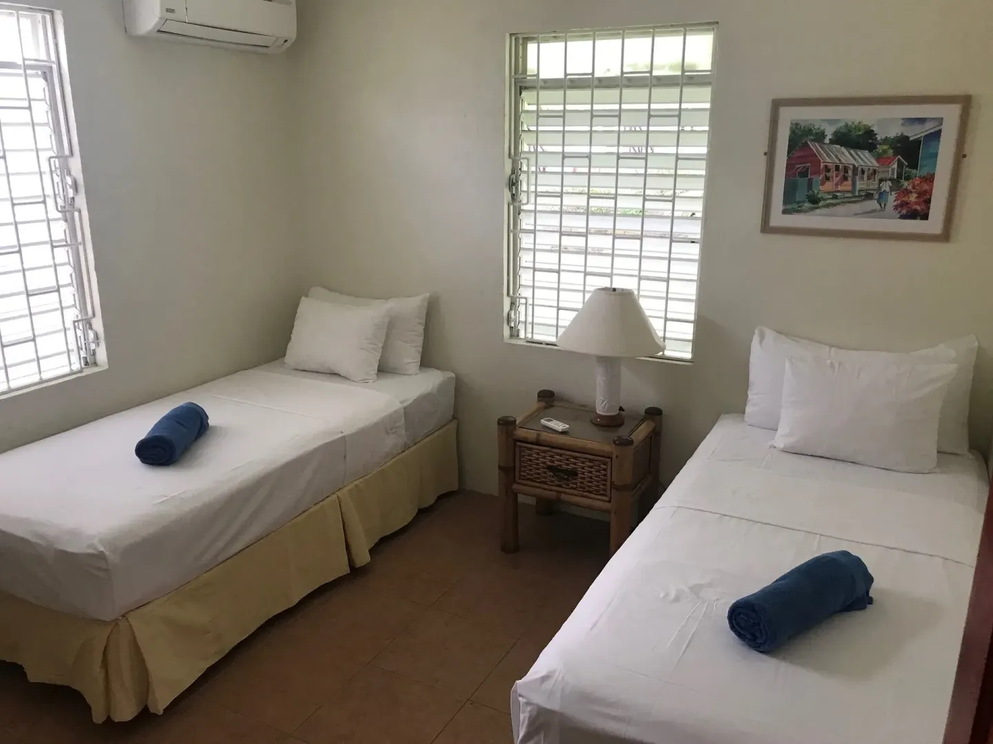 Twin bedroom with two single beds in the apartment at Coconut Court Beach Hotel.