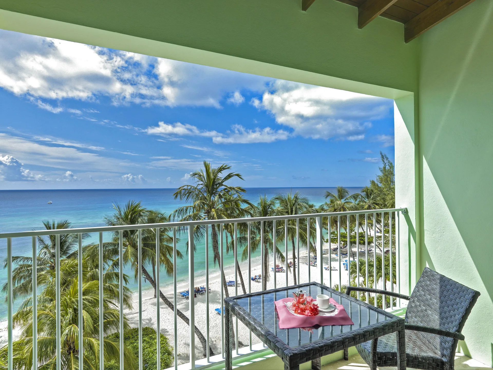 Oceanfront deluxe room balcony with beach views at Coconut Court Beach Hotel.