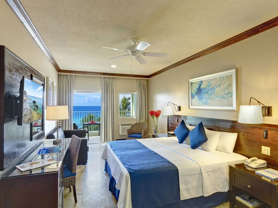 Deluxe Room Oceanfront with king bed and balcony view at Coconut Court Beach Hotel.