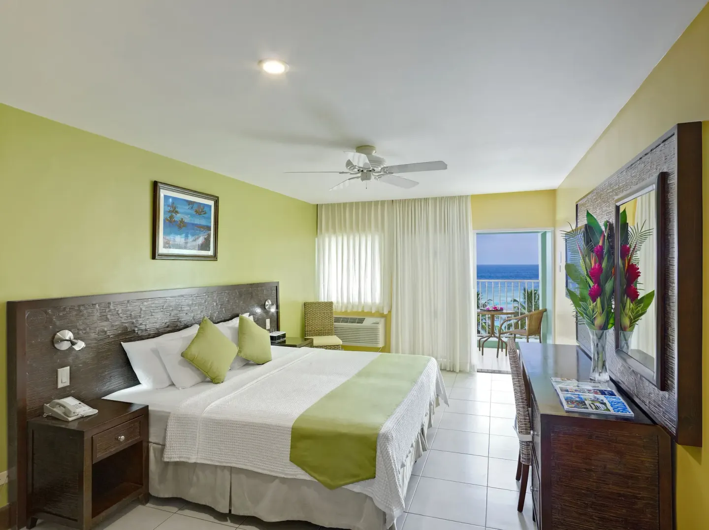 Superior Oceanfront room with bed and balcony sea view at Coconut Court Beach Hotel.