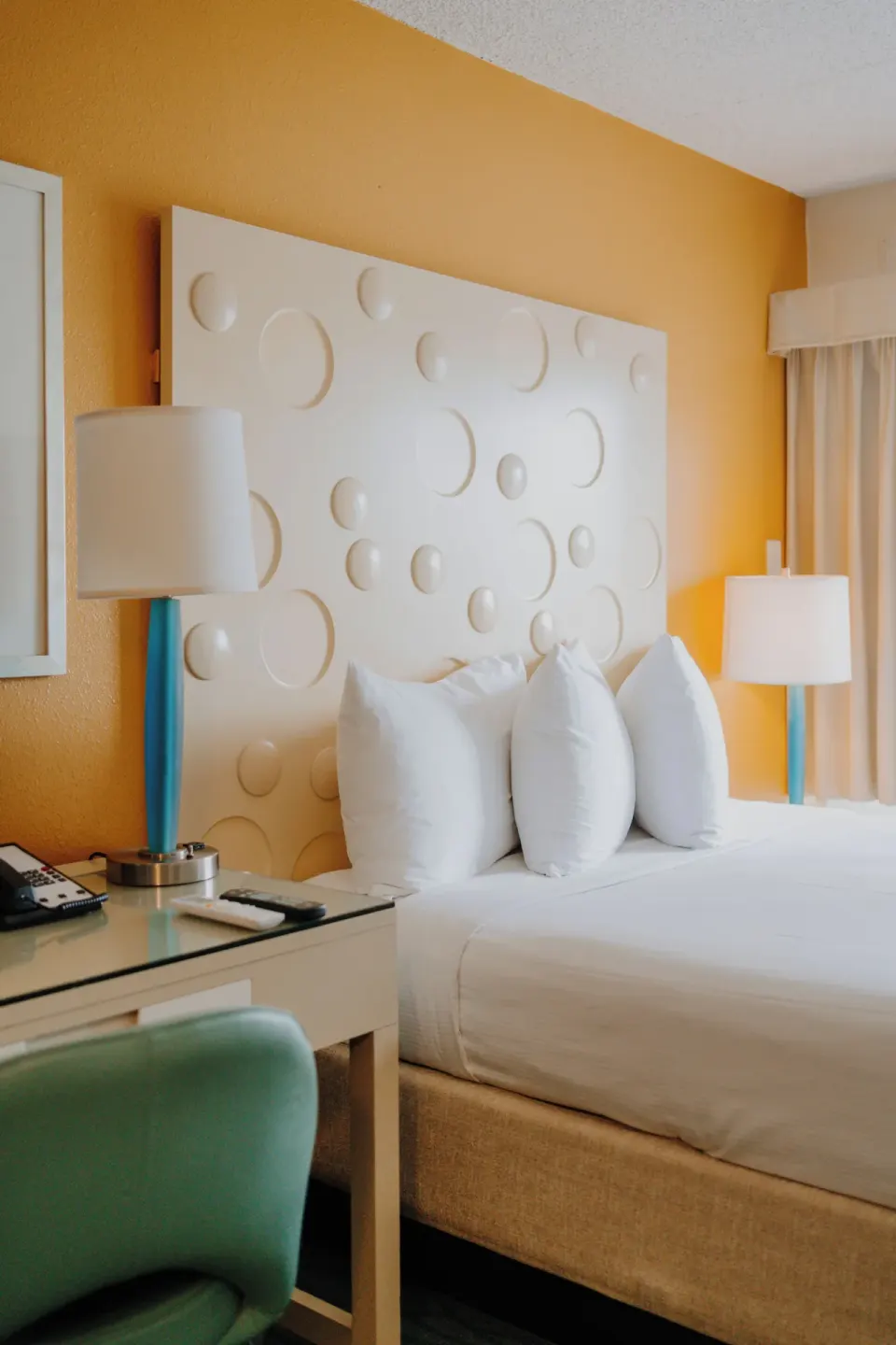 Standard Room City View bed and desk area at Coconut Waikiki Hotel.