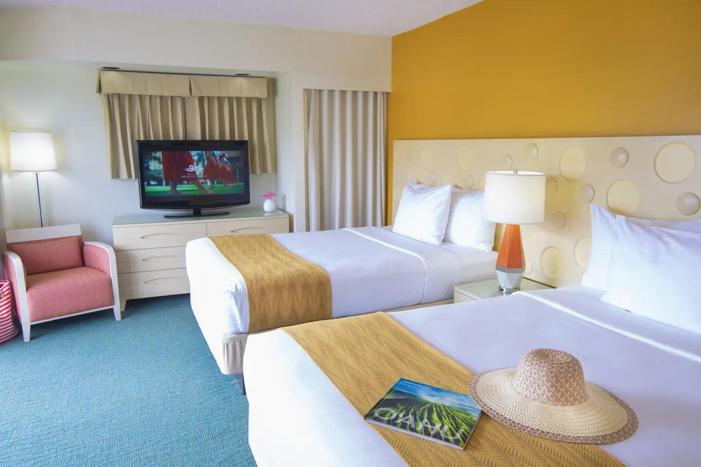 Standard Room Mountain View with two beds and yellow accent wall at Coconut Waikiki Hotel.