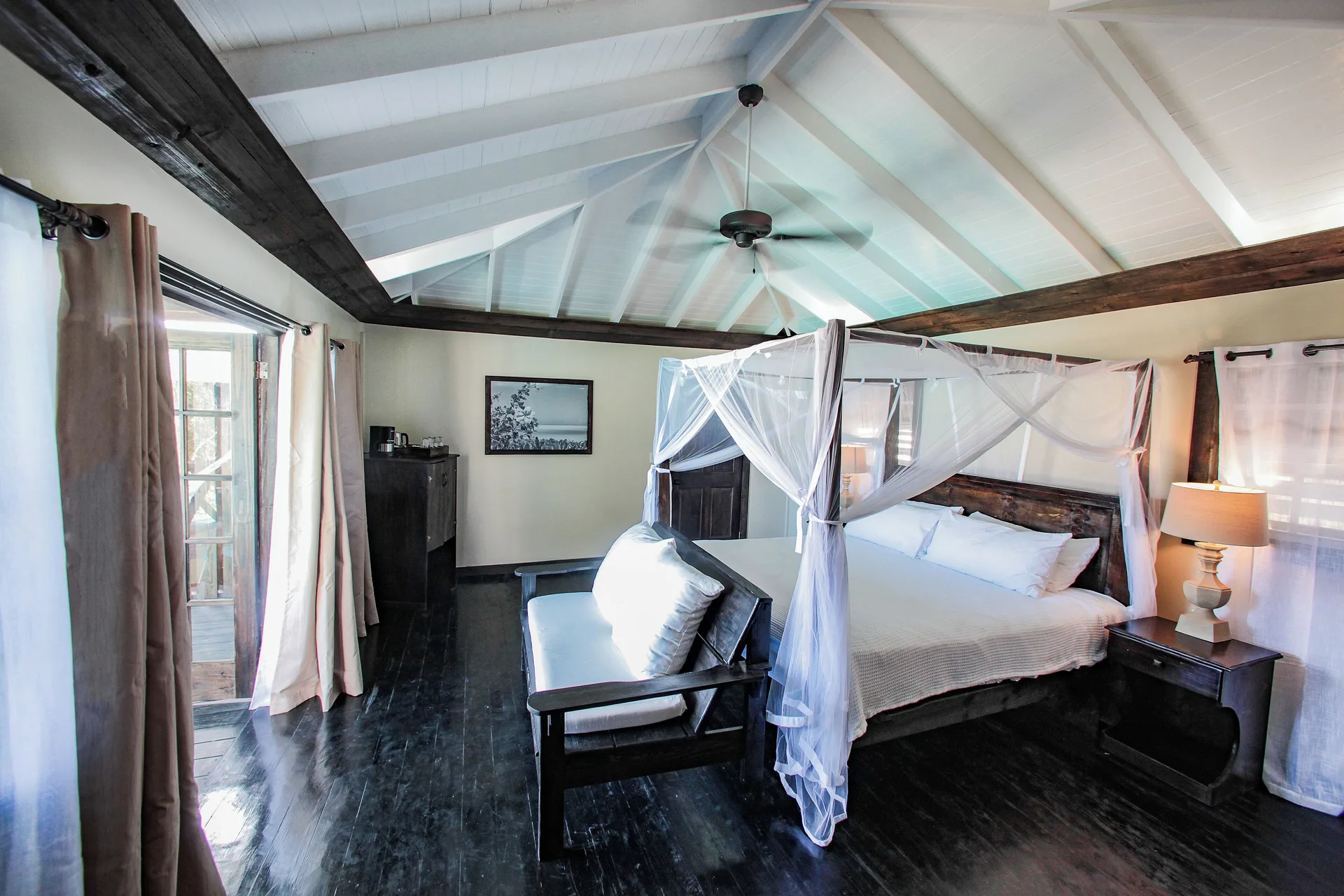 Bay View Pool Cottage bedroom with a four-poster bed and vaulted ceiling at COCOS Hotel.