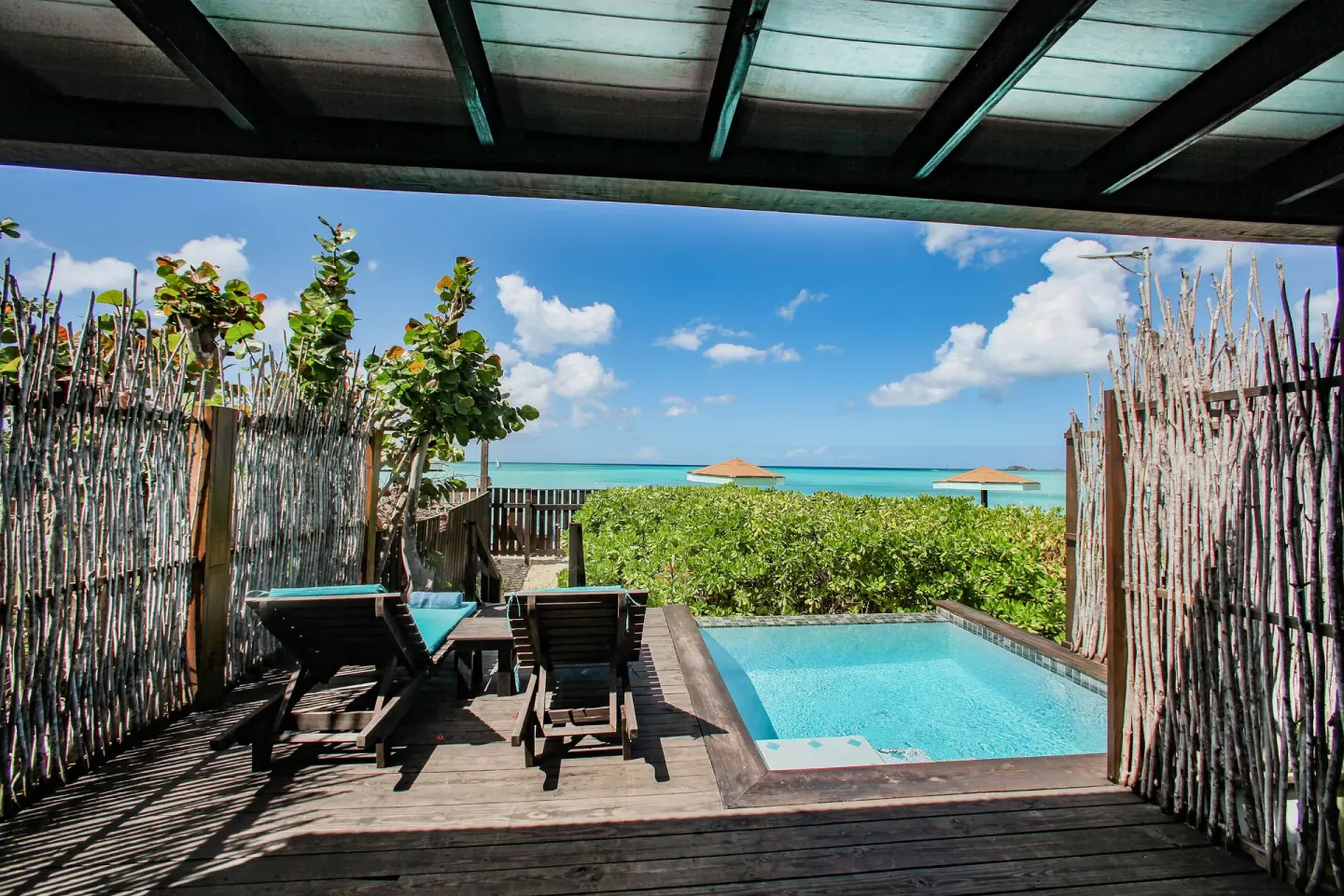 Covered terrace overlooking a private pool and sea at COCOS Hotel.