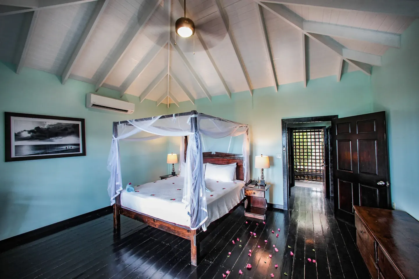 Beach Front Pool Cottage bedroom with four-poster bed at COCOS Hotel.