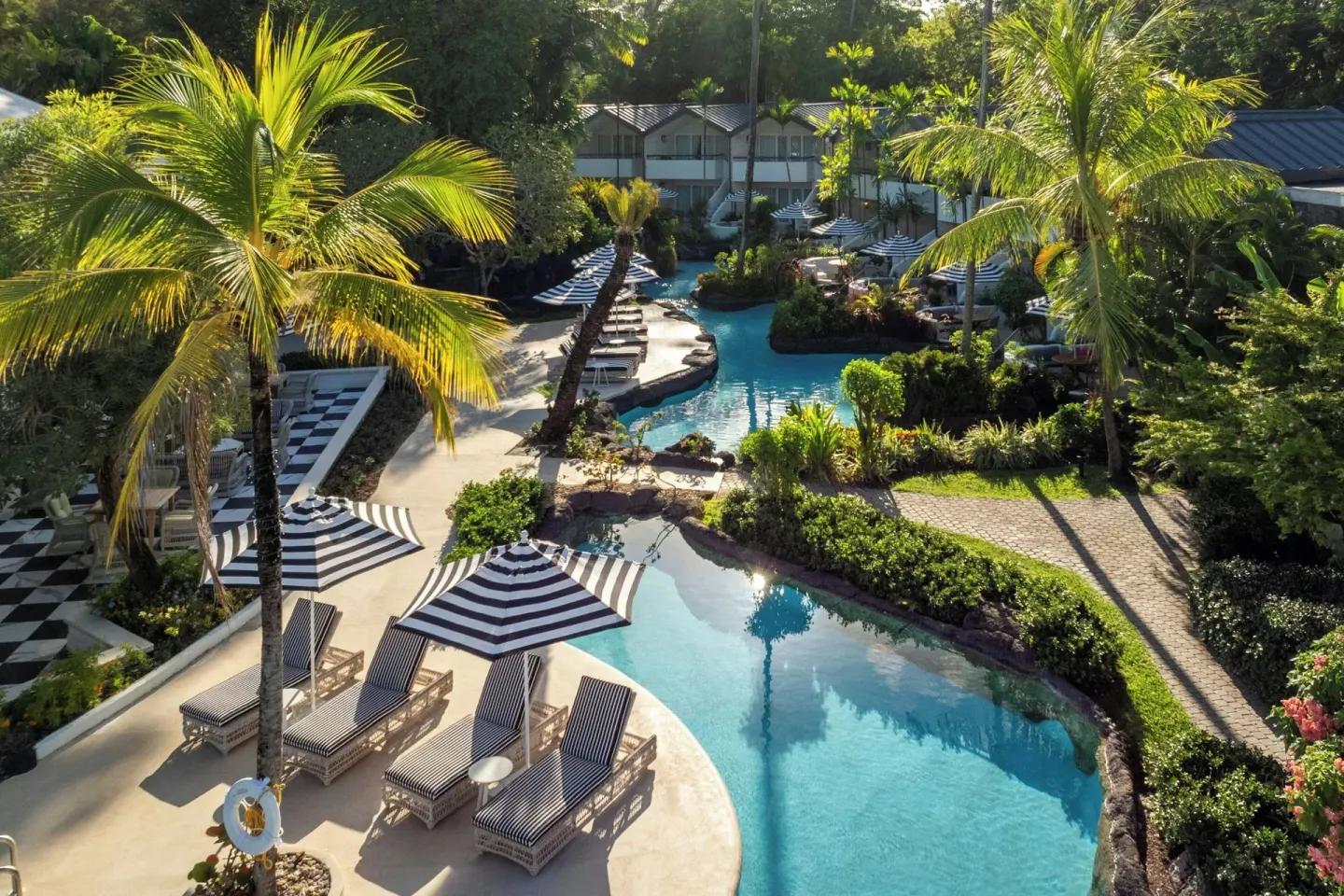 Aerial view of lagoon-style pools, palms and loungers at Colony Club, Barbados.