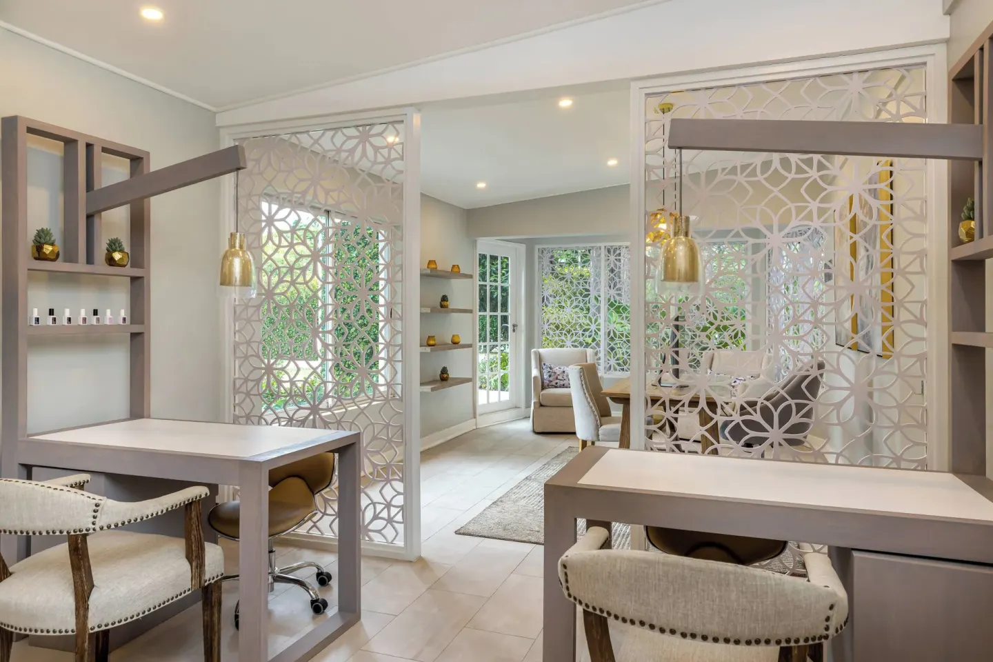 Bright salon with manicure stations and patterned screens at Colony Club, Barbados.