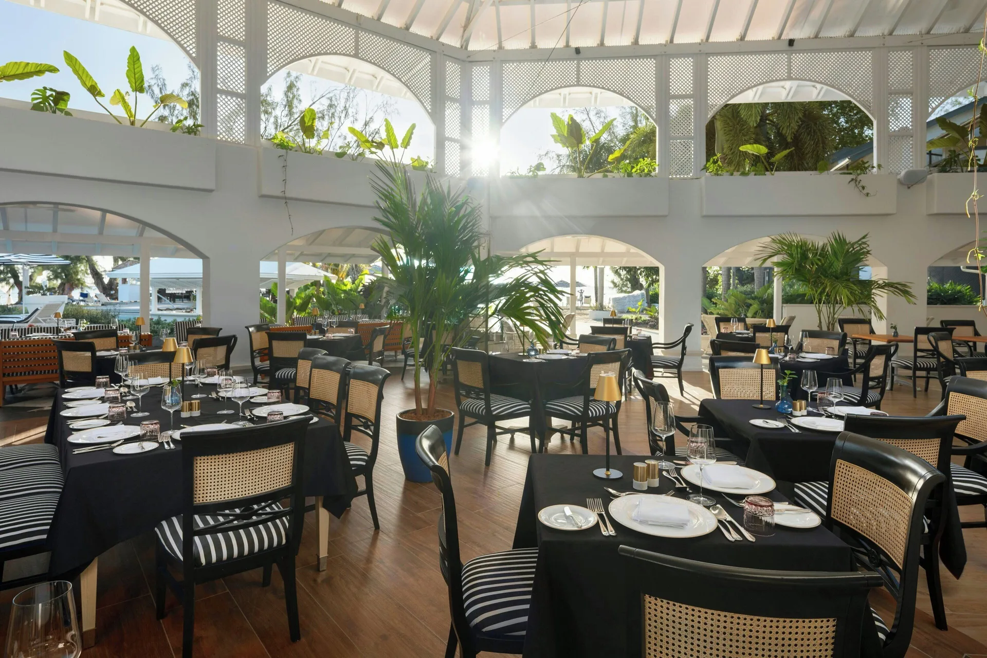 Formal restaurant tables set with black linens at Colony Club, Barbados.