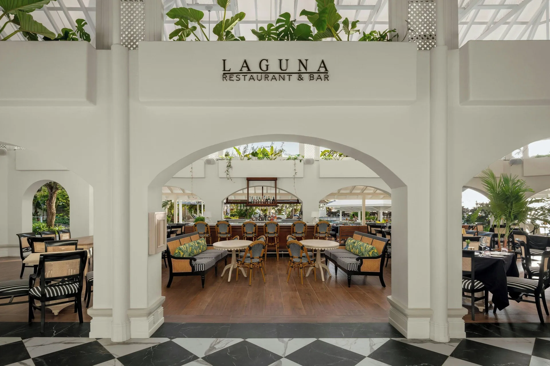 Laguna Restaurant & Bar entrance with seating and bar at Colony Club, Barbados.