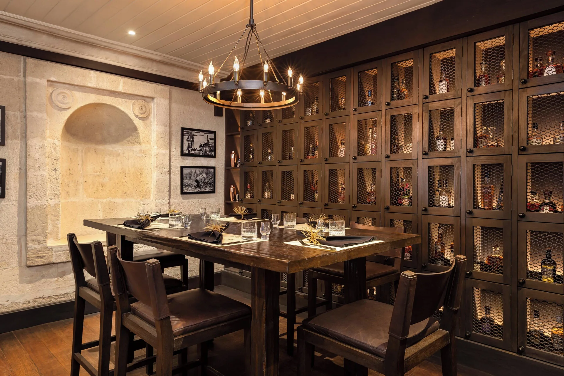 Rum tasting room with a high table and bottle cabinets at Colony Club, Barbados.