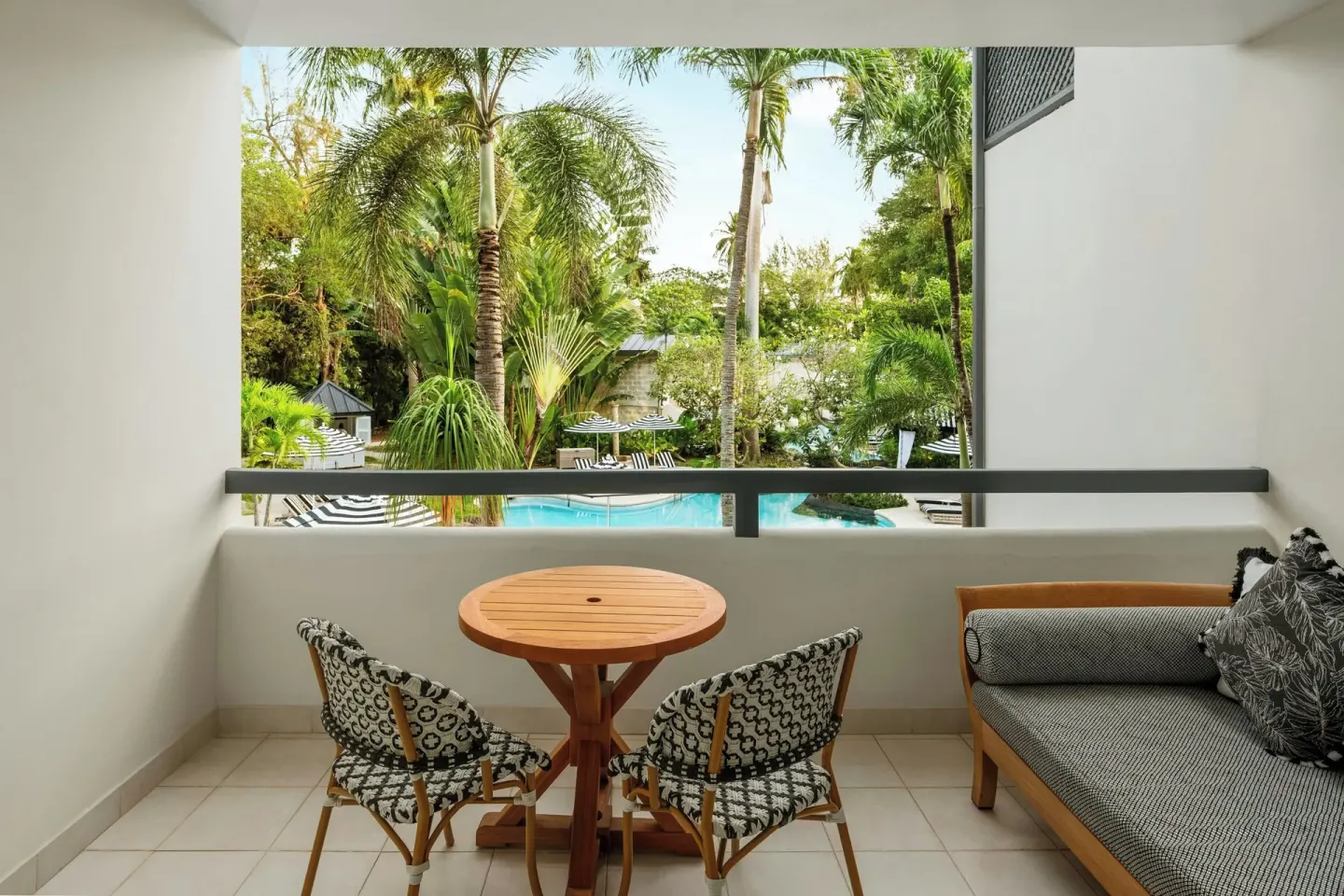 Junior Suite balcony seating overlooking the pool garden at Colony Club, Barbados.