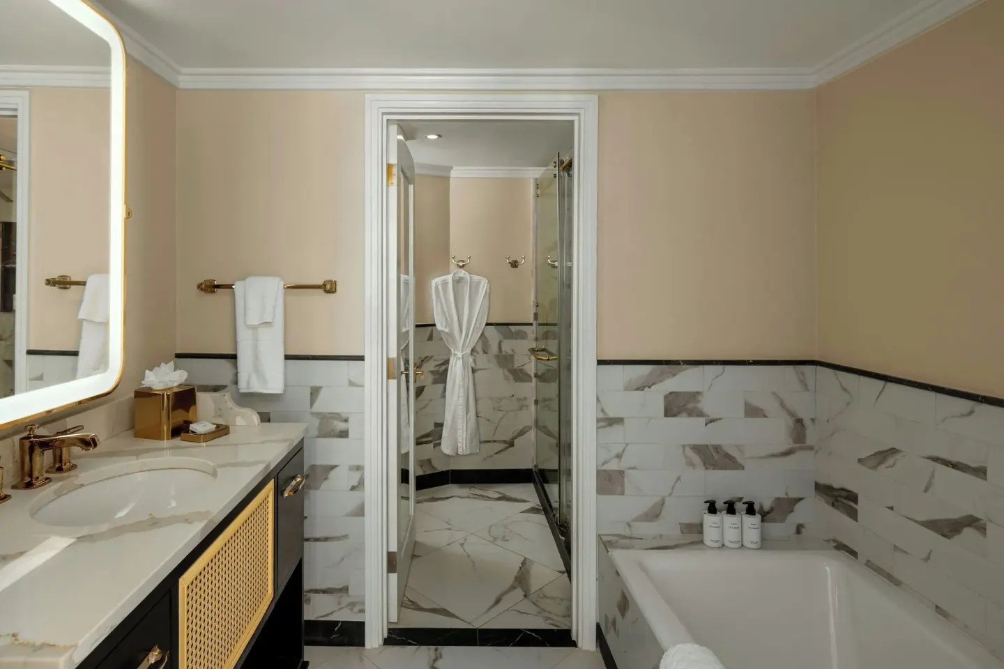 Junior Suite bathroom with vanity, bathtub and glass shower at Colony Club, Barbados.