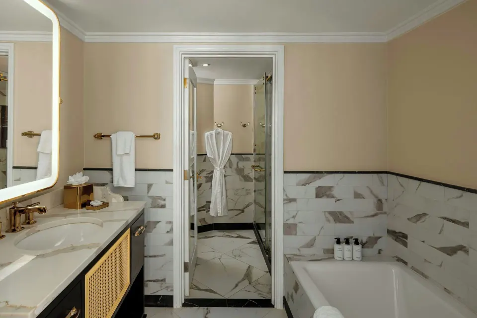 Junior Suite bathroom with vanity, bathtub and glass shower at Colony Club, Barbados.