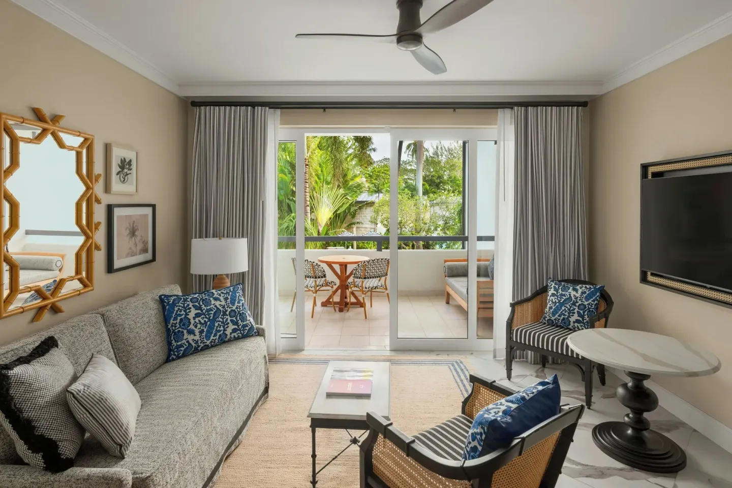 Junior Suite sitting area with balcony doors and garden view at Colony Club, Barbados.