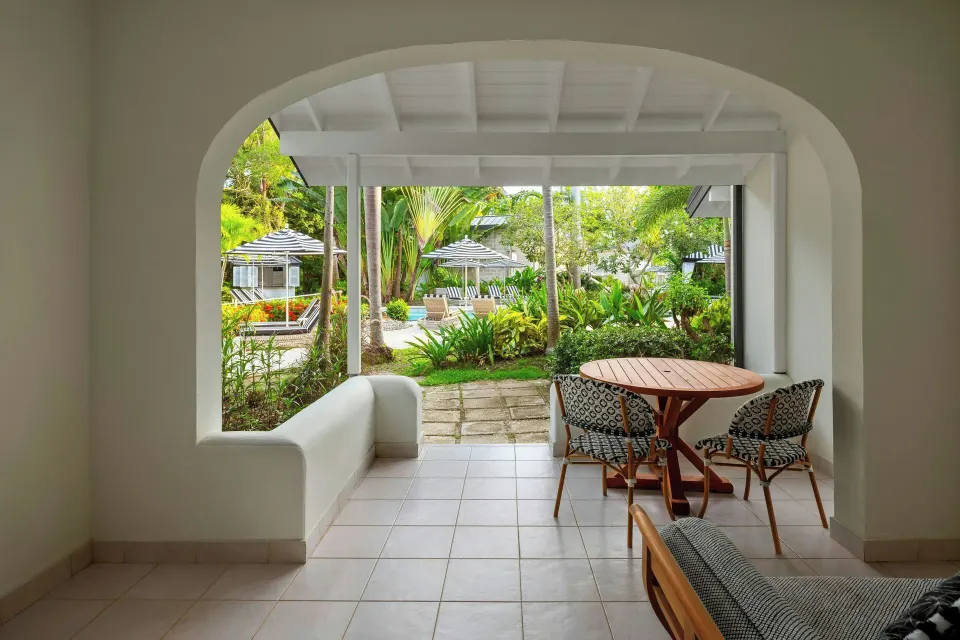 Junior Suite terrace with garden and poolside greenery at Colony Club, Barbados.
