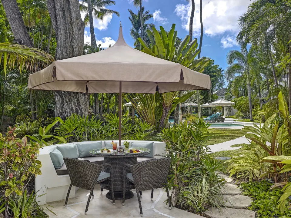 Poolside Luxury Room patio seating in tropical gardens at Colony Club, Barbados.