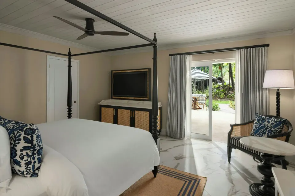 Garden-view room with four-poster bed and patio doors at Colony Club, Barbados.