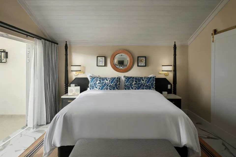 Guest room with four-poster bed and balcony doors at Colony Club, Barbados.