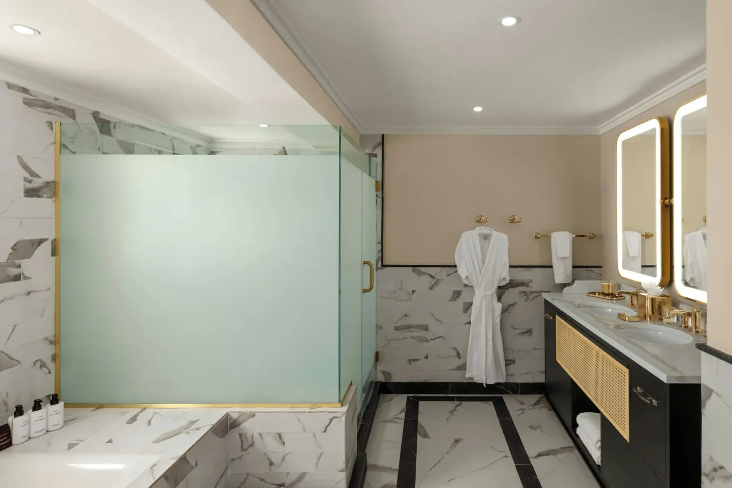 Suite bathroom with tub, frosted glass shower, and double vanity at Colony Club, Barbados.
