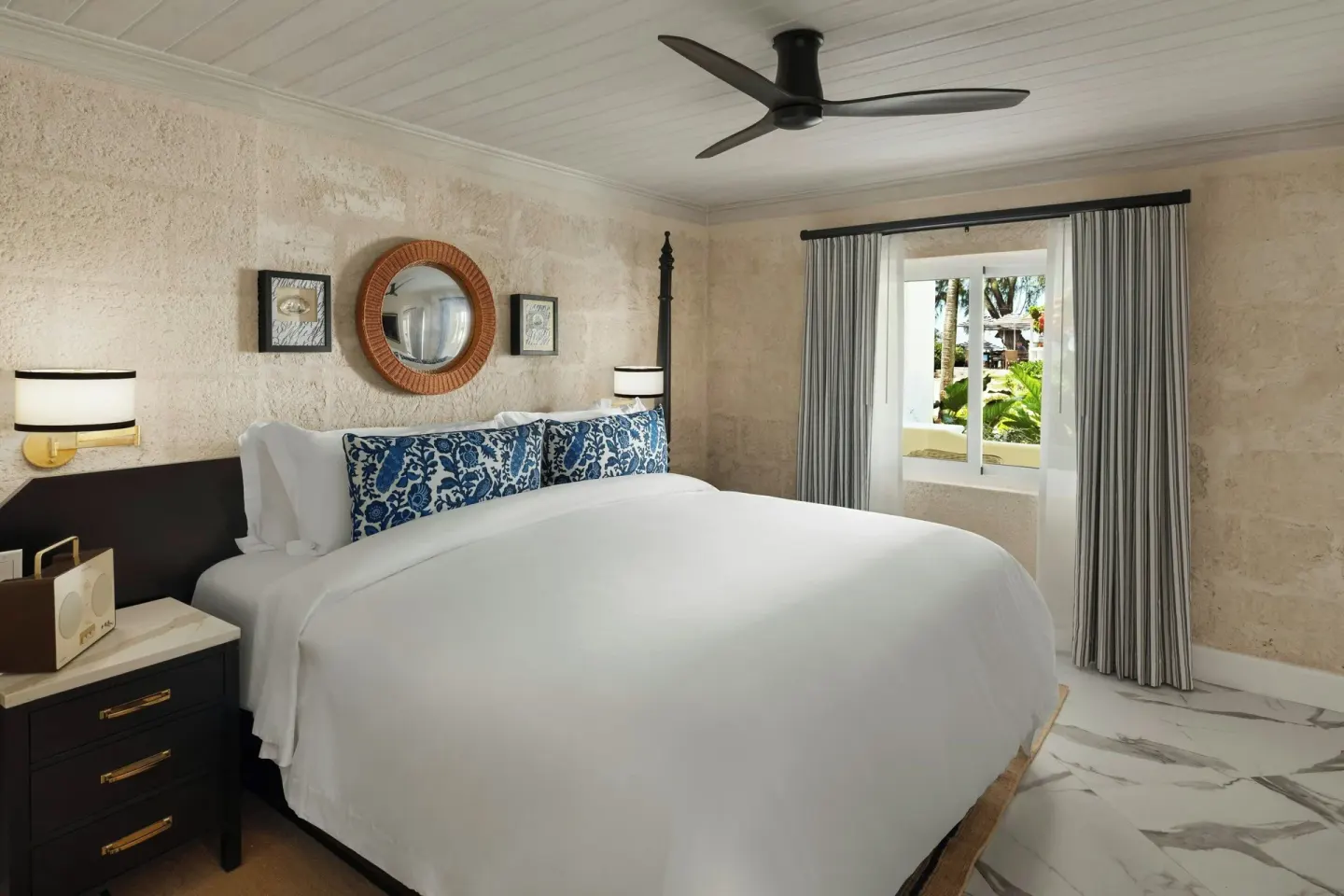 Suite bedroom with a king bed and garden-facing window at Colony Club, Barbados.