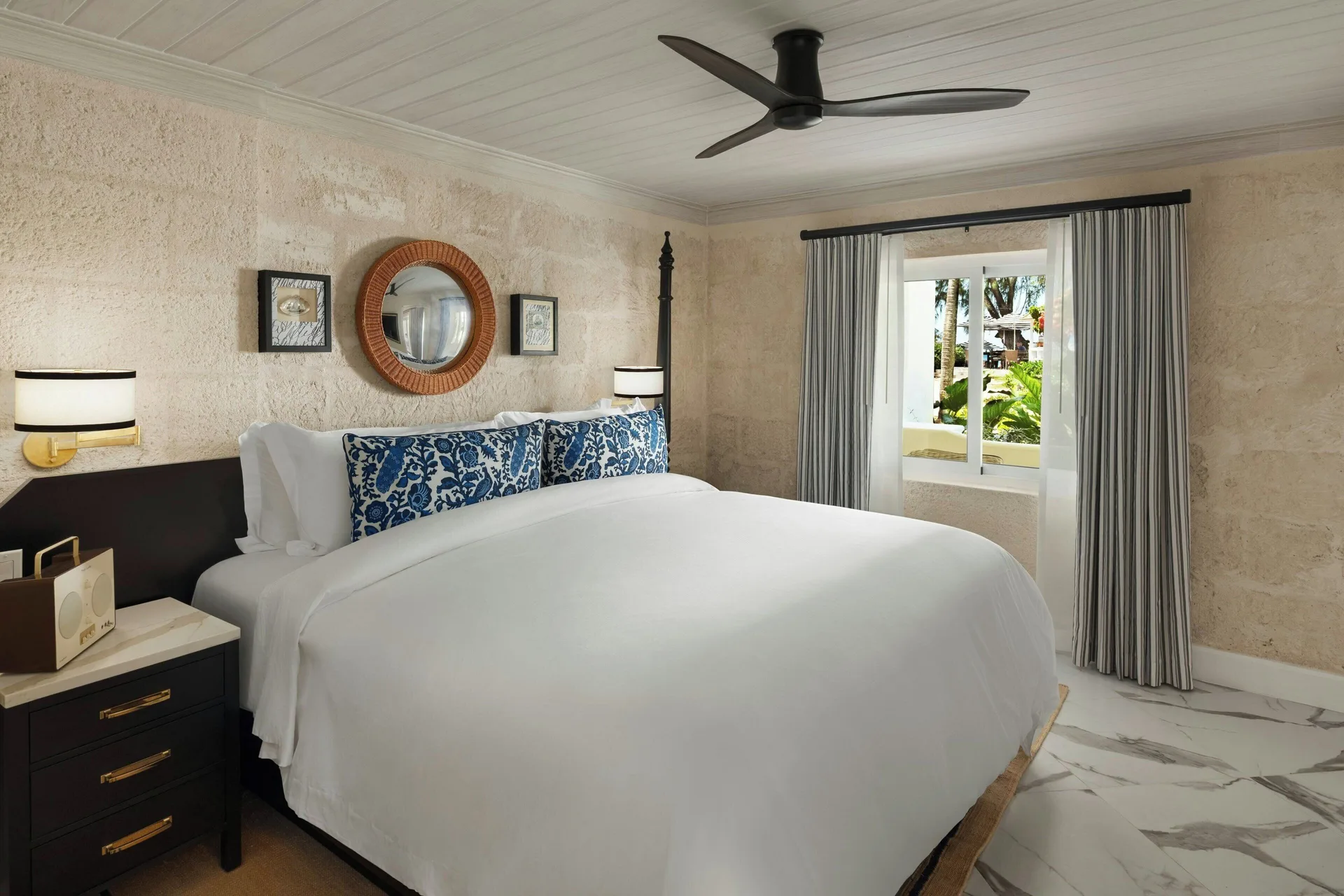 Suite bedroom with a king bed and garden-facing window at Colony Club, Barbados.