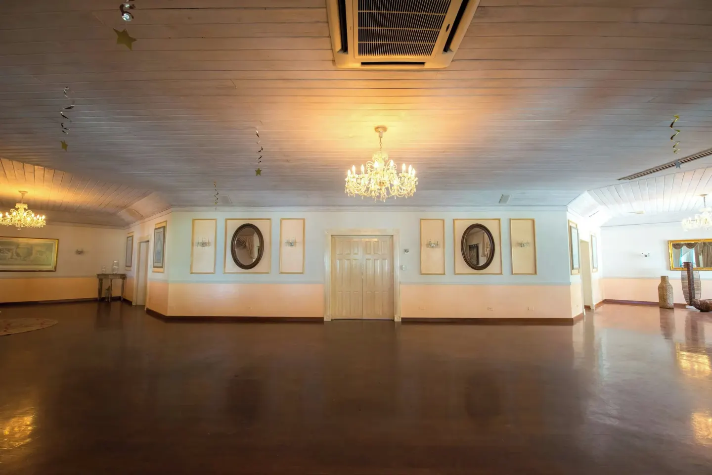 Empty event room with chandeliers and polished floor at Colony Club, Barbados.