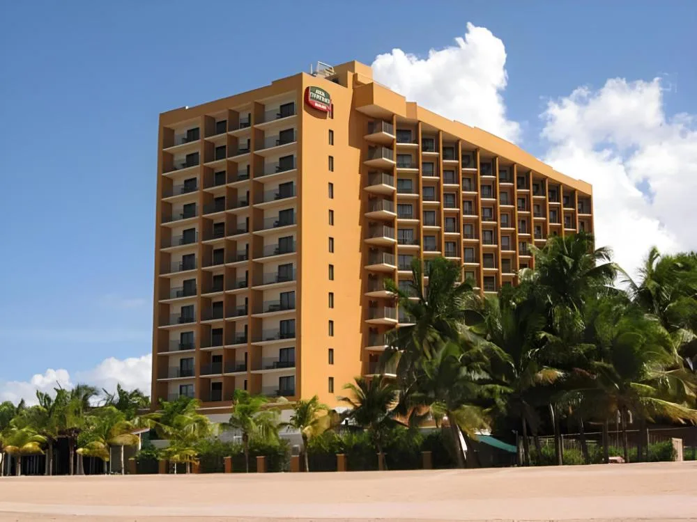 Courtyard well-known branded beach-area hotel with modern exterior and pool amenities near Isla Verde, San Juan, Puerto Rico.