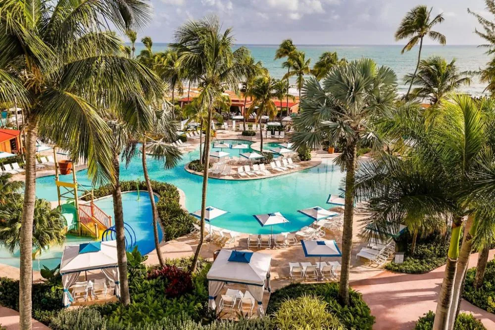 Wyndham Grand Rio Mar Rainforest Beach and Golf Resort large beach and golf resort with tropical pools near rainforest in Río Grande, Puerto Rico.