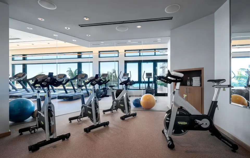 Exercise bikes and mirrored walls in the fitness center at Condado Vanderbilt Hotel.