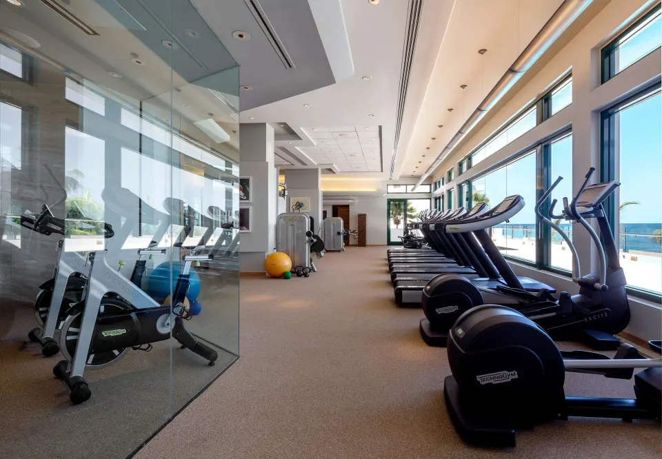 Fitness center with treadmills and ocean-view windows at Condado Vanderbilt Hotel.