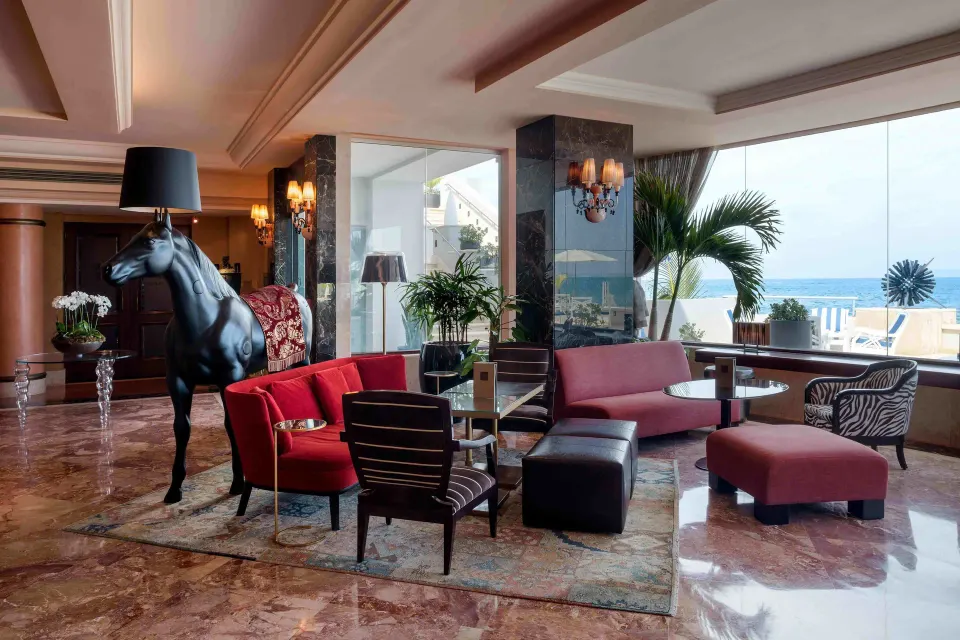 Ocean-facing lounge seating with a horse sculpture at Condado Vanderbilt Hotel.
