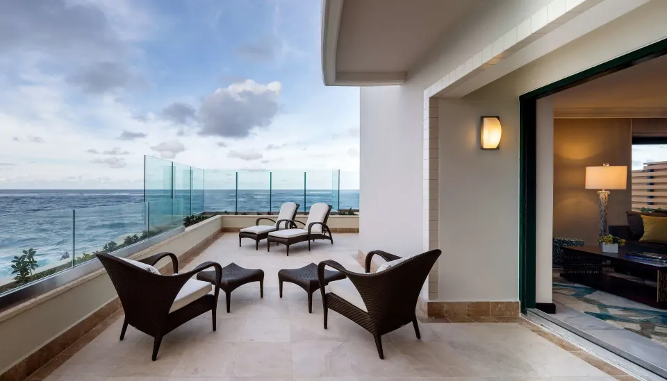 Oceanfront terrace with lounge chairs at Condado Vanderbilt Hotel.