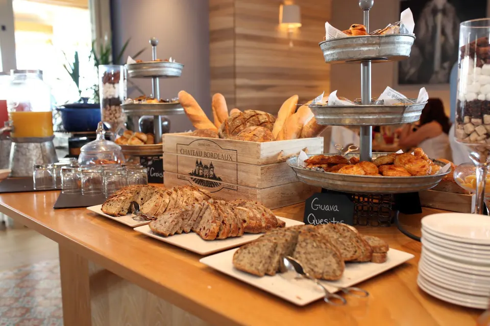 Breakfast buffet with pastries, breads, and drinks at Condado Vanderbilt Hotel.